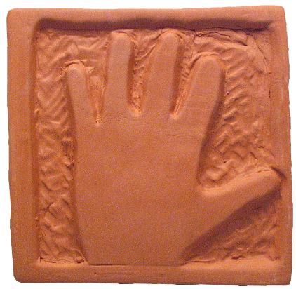 Hand impression in terra cotta clay, showcasing texture and detail for pottery techniques or ceramic decoration projects.