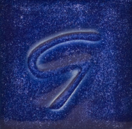 Rich cobalt blue ceramic glaze sample with a smooth, glossy finish and the letter G embossed in the center.