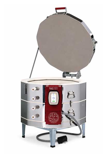 Skutt-kiln-KMT-1218 Skutt ceramic kiln with a digital controller, open lid, and stainless steel body for pottery firing and clay projects.
