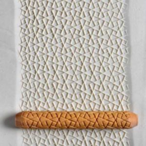Textured white clay slab with a patterned rolling pin creating geometric impressions, ideal for pottery decoration techniques.