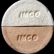 Two ceramic samples labeled IMCO, one is a white clay body and the other is a tan clay body, highlighting material differences.