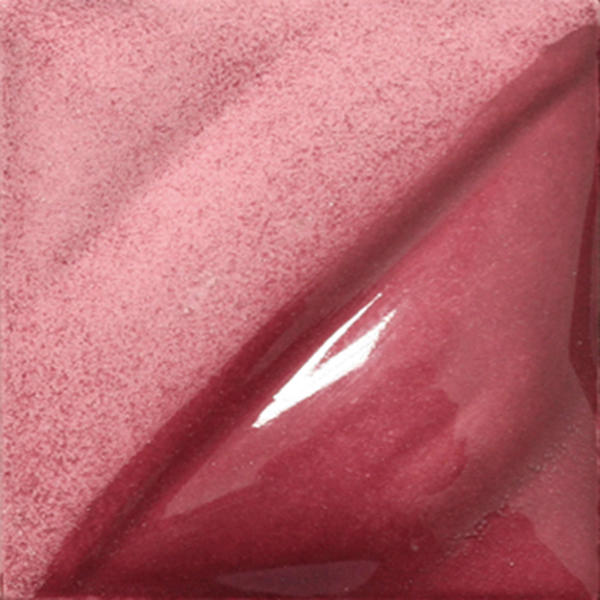 Glossy red ceramic glaze sample with shimmering texture, showcasing a rich, vibrant color for pottery finishes.