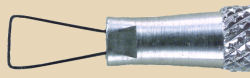 Close-up of a ceramic trimming tool with a textured metal handle and a wire loop for detailed shaping of clay.