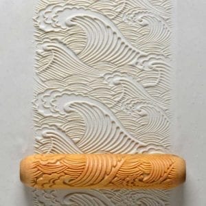 Clay impression texture depicting waves, created with a decorative rolling pin, suitable for pottery and ceramic projects.