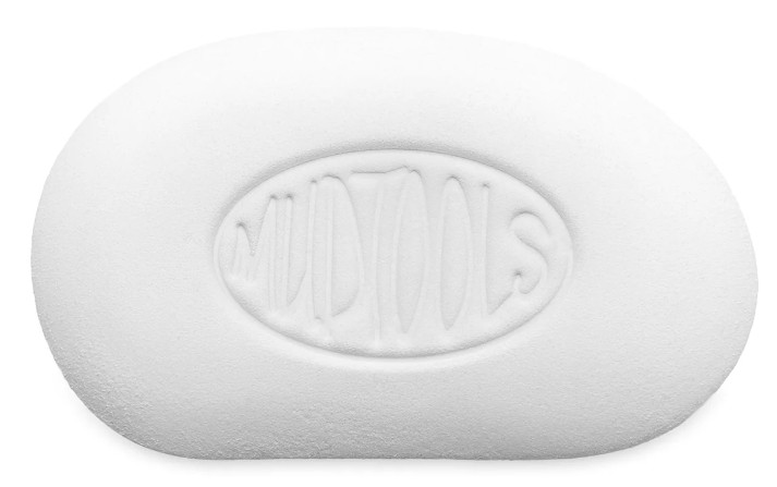 White Mudtools rib for shaping clay, featuring an embossed logo, ideal for smoothing pottery surfaces in the studio.