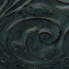 Textured dark blue-green ceramic glaze with swirling patterns, showcasing depth and a glossy finish. Ideal for decorative pottery.