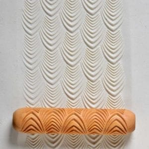 Embossed clay texture pattern featuring leaf shapes using a wooden printing tool, ideal for ceramic decoration.