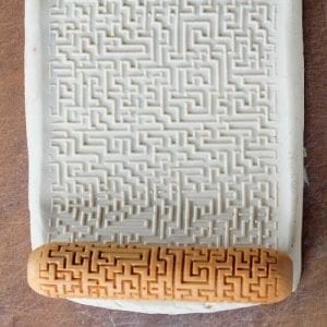 Textured white clay slab featuring a labyrinth pattern created with a wooden texture roller from Georgies Ceramic & Clay Company.