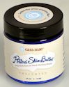 Jar of Phytonutrient Skin Butter from Cara Maé, featuring a blue and white design, used for clay-based skin care.