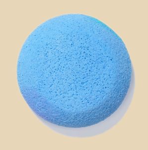 Round blue sponge for pottery cleanup, ideal for smoothing clay surfaces and applying glazes in ceramic projects.