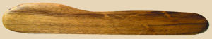 Wooden rib tool for shaping clay in pottery, used for smoothing and refining ceramic pieces during crafting.