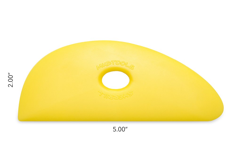 Yellow Mudtools rib tool with a curved design and central hole, measuring 5 inches by 2 inches, ideal for pottery shaping.