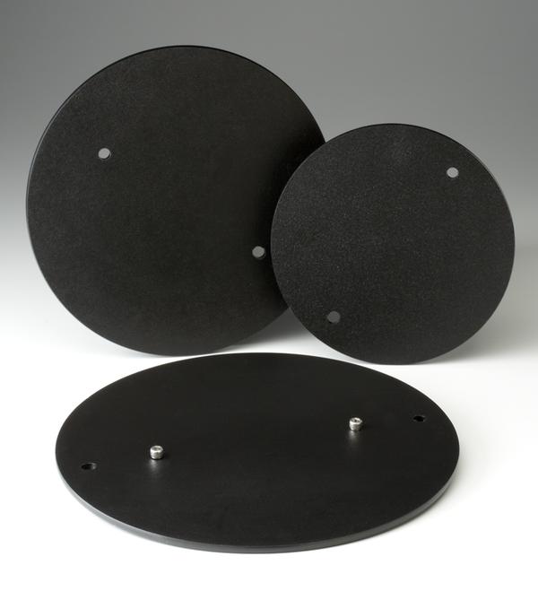 Three round black batts with smooth surfaces and holes for mounting, ideal for pottery wheel use and clay projects.
