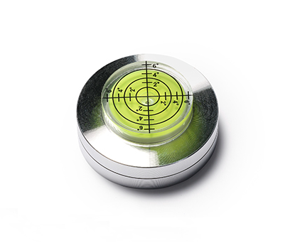 Metal level with a clear bubble, marked with measurements, used for ensuring precise alignment in ceramic projects.