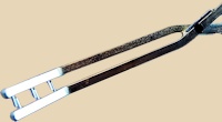 Ceramic trimming tool with a curved blade and wooden handle, used for shaping pottery and refining edges in ceramics.