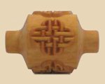 Carved wooden pottery tool featuring an intricate knot design, used for decorative carving in ceramics and pottery.