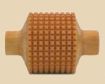 Textured wooden rib tool for shaping clay, featuring a grid pattern, used in pottery and ceramics for precise detailing.
