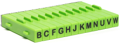 Green ceramic glaze testing tiles labeled with letters B, C, F, G, H, J, K, M, N, U, V, used for color sampling.