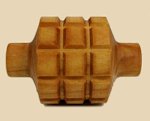 Wooden clay tool with a textured surface, used for shaping and imprinting patterns on ceramics and pottery.