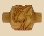 Carved wooden rib tool featuring an intricate design, ideal for shaping and detailing ceramics and pottery projects.