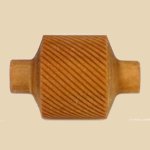 Ceramic rib tool with a textured surface, used for shaping and smoothing clay in pottery and sculpture.