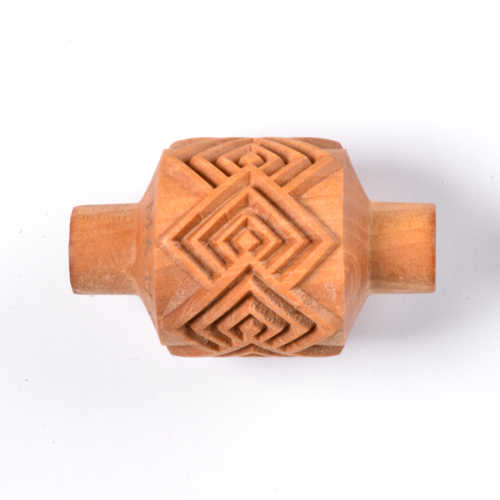 Hand-carved clay pottery stamp with geometric patterns for decoration in ceramic projects, ideal for texture application.