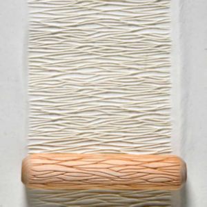 Ceramic texture maker with a clay surface displaying a wavy pattern, ideal for adding dimension to pottery projects.