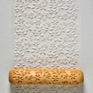 Textured white clay rolled with a floral pattern roller, ideal for decorating pottery or sculpture projects at Georgies.
