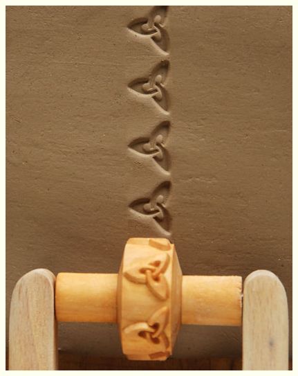 Detailed impression of a clay slab marked with a decorative rolling pin, showcasing intricate patterns for pottery decoration.