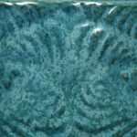 Textured turquoise ceramic tile with swirling patterns, showcasing a glossy glaze finish typical of high-quality pottery.