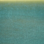 A close-up of a glossy teal ceramic glaze with subtle texture variations, ideal for pottery and decorative pieces.