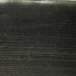 Dark textured clay surface with subtle variations, ideal for ceramic sculpting or pottery decoration techniques.