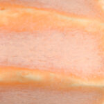 Textured ceramic clay with orange and beige swirls, ideal for sculpting and decorative pottery applications.