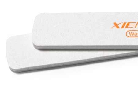 Two white Xiem ceramic rib tools for smoothing and shaping clay in pottery, featuring a smooth finish for delicate work.