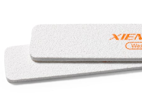 Two Xien Series white ceramic sponges, textured for cleanup and smoothing, ideal for pottery and clay decoration.