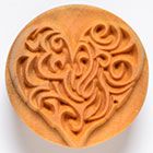 Detailed ceramic texture stamp featuring a heart design with swirling patterns, ideal for pottery decoration and impressions.