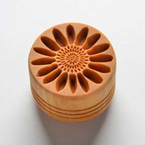 A textured clay stamp with a floral design, used for decorating pottery and ceramics at Georgies Ceramic & Clay Company.
