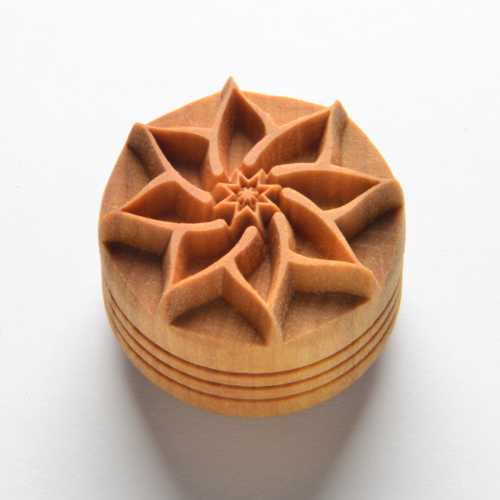 Wooden impression stamp featuring a carved floral design, ideal for decorating clay ceramics and pottery surfaces.