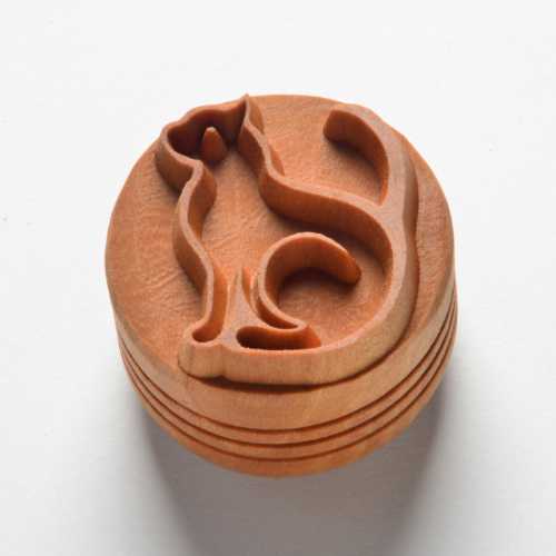 Wooden ceramic stamping tool featuring a cat design, ideal for creating unique textures on pottery or clay projects.