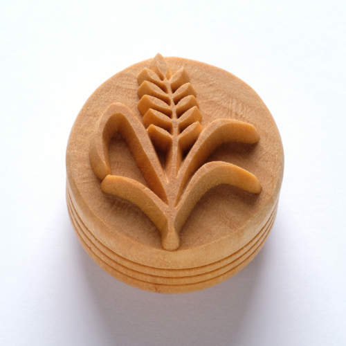 Ceramic stamp tool featuring a leaf design, ideal for impressing patterns in clay or decorating pottery surfaces.