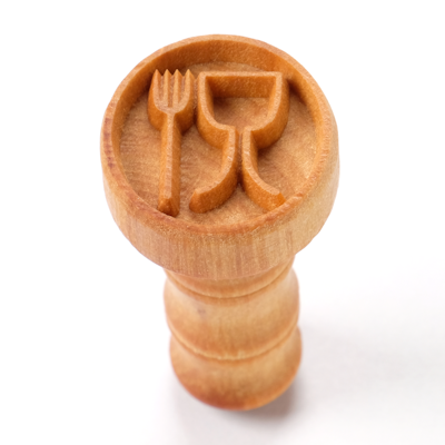 Wooden clay stamp with fork and goblet design, used for decorating ceramics at Georgies Ceramic & Clay Company.