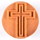 Round clay mold featuring a raised cross design, ideal for pottery decoration and ceramic art projects.