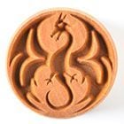 Ceramic stamp featuring a dragon design, perfect for creating textured patterns on clay surfaces.