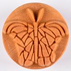 Ceramic butterfly stamp in reddish-brown clay, showcasing intricate detailing for pottery decoration and texture.