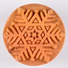 Textured ceramic stamp featuring a snowflake design, ideal for imprinting on clay or pottery surfaces.