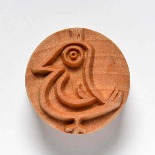 Wooden clay stamp featuring a stylized bird design, used for decorating pottery and ceramics at Georgies Ceramic & Clay Company.