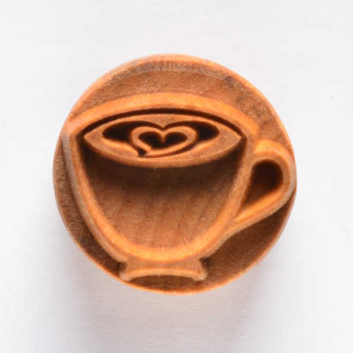 Ceramic stamp featuring a heart design inside a cup, ideal for decorating pottery pieces at Georgies Ceramic & Clay Company.
