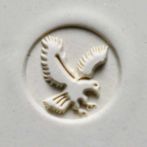 Carved ceramic stamp featuring an eagle design, used for decorating pottery and clay projects.