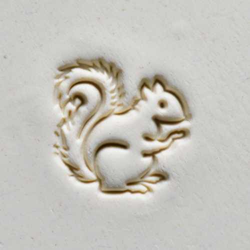 Squirrel relief design on white clay, ideal for ceramic decoration and sculpting projects at Georgies Ceramic & Clay Company.