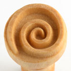 Close-up of a spiral wood clay tool used for shaping and decorating pottery at Georgies Ceramic & Clay Company.